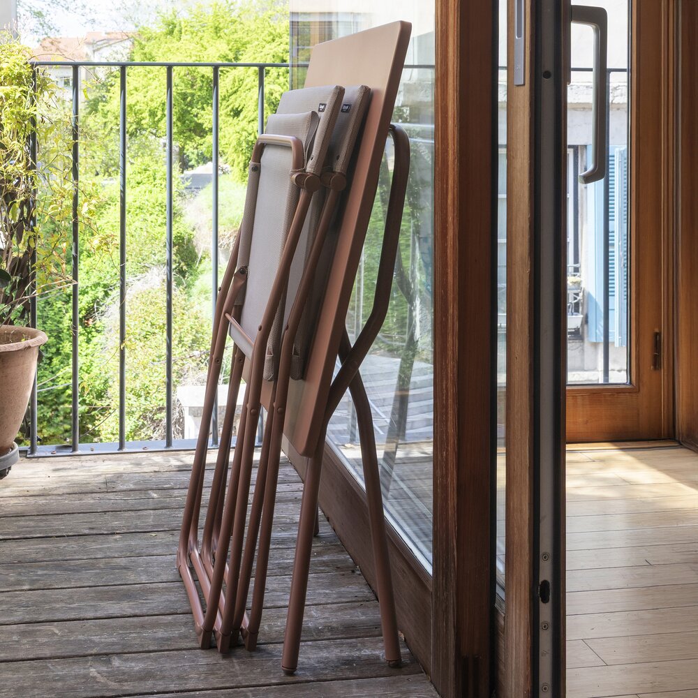 folding table with chairs leans against a balcony door