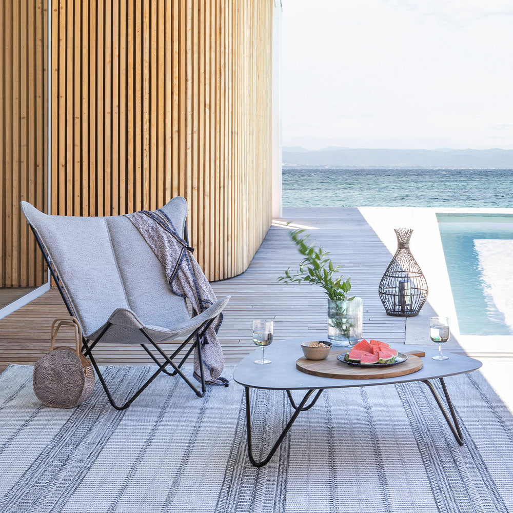 Outdoor seating area with a butterfly chair and a table